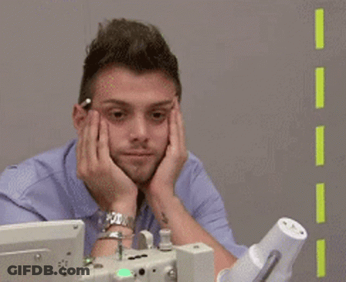 Man Sitting In Front Of Computer With Hands On Face GIF