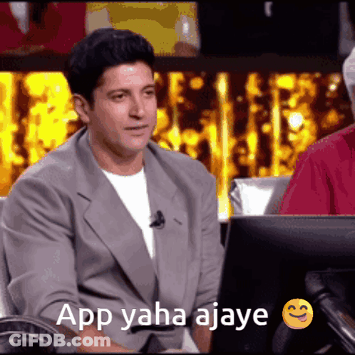 A Man Is Sitting In Front Of A Computer With The Words App Yaha Ajay Written On The Screen GIF