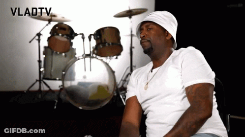A Man Is Sitting In Front Of A Drum Set With Vladtv Written On The Bottom GIF