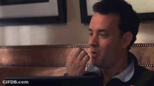 A Man Is Sitting In Front Of A Laptop Computer . GIF