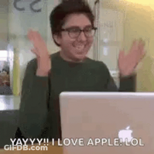 A Man Is Sitting In Front Of A Laptop Computer . GIF