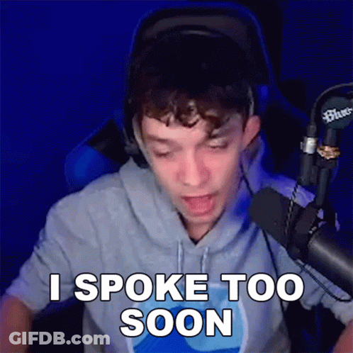 A Man Is Sitting In Front Of A Microphone And Says I Spoke Too Soon . GIF