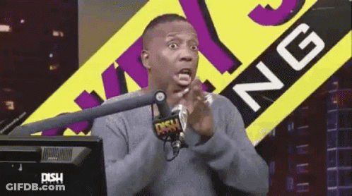 A Man Is Sitting In Front Of A Microphone In Front Of A Sign That Says Dish Radio GIF