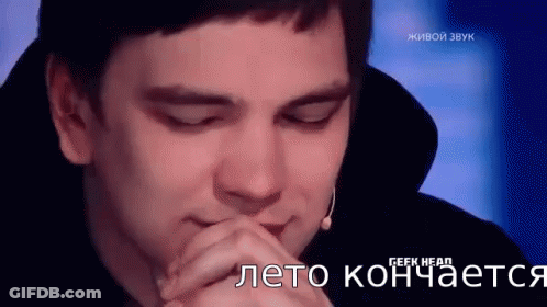A Man Is Sitting In Front Of A Microphone With His Eyes Closed And His Hands Folded . GIF