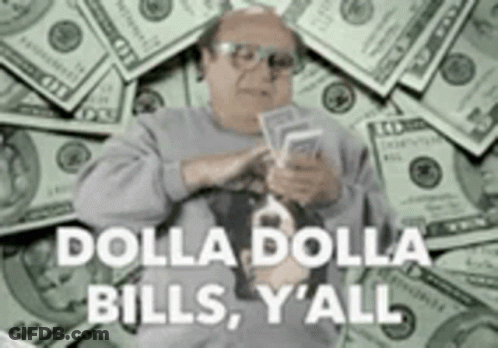 A Man Is Sitting In Front Of A Pile Of Money Holding A Bunch Of Money . GIF