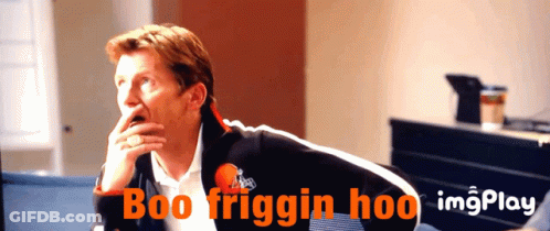 A Man Is Sitting In Front Of A Screen That Says Boo Friggin Hoo On It GIF