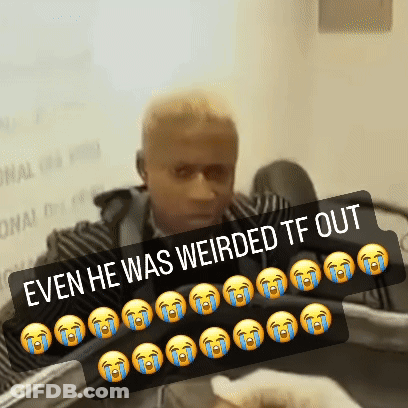 A Man Is Sitting In Front Of A Sign That Says " Even He Was Weird Tf Out " GIF