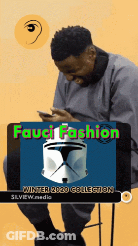 A Man Is Sitting In Front Of A Sign That Says Fauci Fashion Winter 2020 Collection GIF