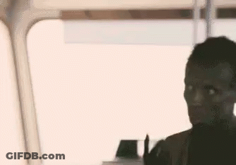 A Man Is Sitting In Front Of A Window On A Bus And Looking Out The Window . GIF