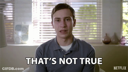 A Man Is Sitting In Front Of A Window With Blinds And Says That 'S Not True GIF