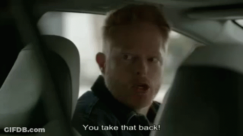 A Man Is Sitting In The Back Seat Of A Car Talking To Another Man . GIF