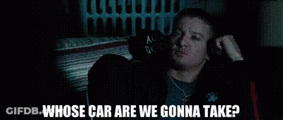 A Man Is Sitting In The Back Seat Of A Car Talking To Another Man . GIF