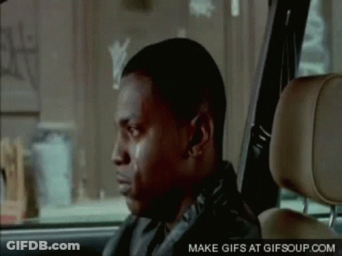 A Man Is Sitting In The Back Seat Of A Car With His Eyes Closed . GIF