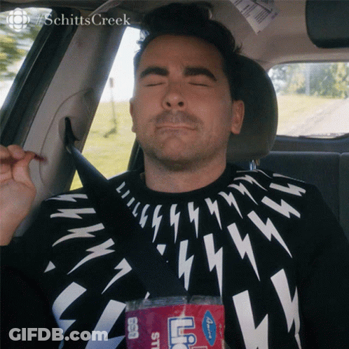 A Man Is Sitting In The Back Seat Of A Car With His Eyes Closed And A Bottle Of Ice Tea GIF
