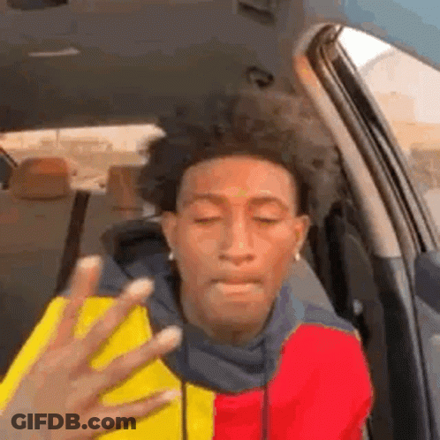 A Man Is Sitting In The Back Seat Of A Car With His Eyes Closed And A Hand Reaching Out Towards Him . GIF