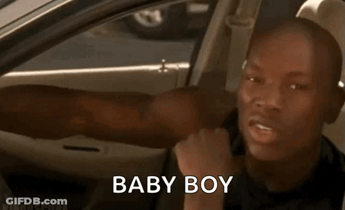 A Man Is Sitting In The Back Seat Of A Car With His Tongue Out And The Words Baby Boy Written On The Screen . GIF