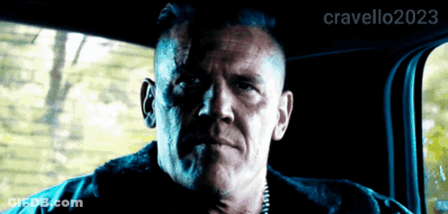 A Man Is Sitting In The Back Seat Of A Car With The Hashtag Cravello2023 On The Bottom GIF