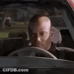 A Man Is Sitting In The Driver 'S Seat Of A Car . GIF