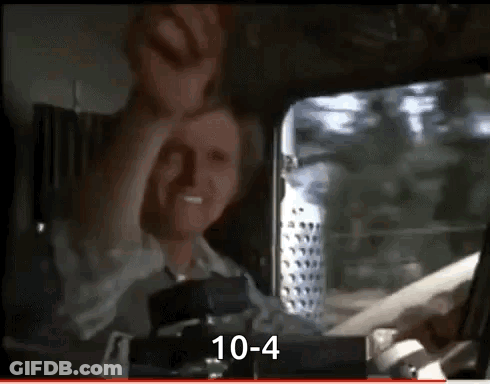 A Man Is Sitting In The Driver 'S Seat Of A Truck And Making A Face . GIF