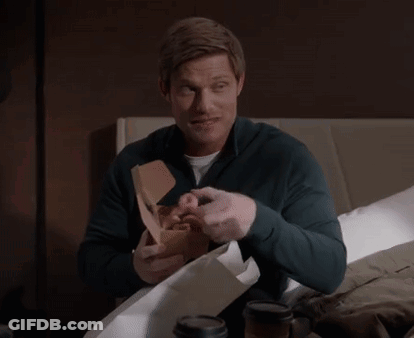 Man Sitting On Bed Holding Donut Box GIF