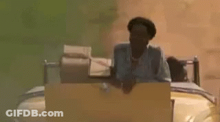 A Man Is Sitting On A Bed In A Car . GIF