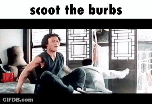 A Man Is Sitting On A Bed In A Room With The Words Scoot The Burbs Written Above Him . GIF