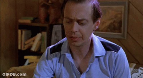 A Man Is Sitting On A Bed Looking At A Ring GIF