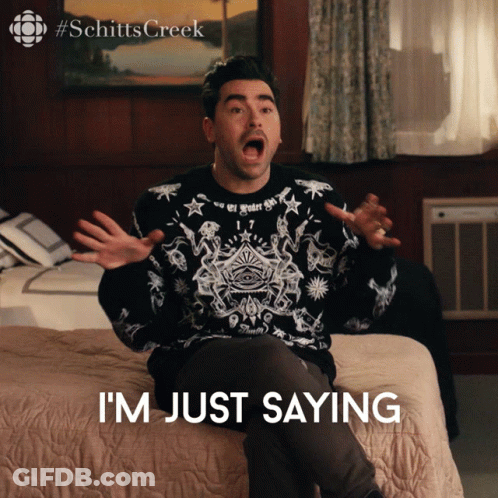 A Man Is Sitting On A Bed With His Mouth Open And The Words I 'M Just Saying Below Him GIF