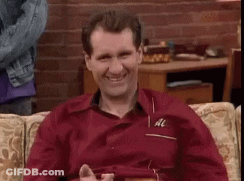 A Man Is Sitting On A Couch And Giving A Thumbs Up . GIF