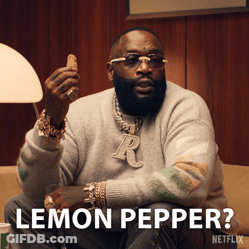 A Man Is Sitting On A Couch And Holding A Chicken Nugget And The Caption Says Lemon Pepper GIF