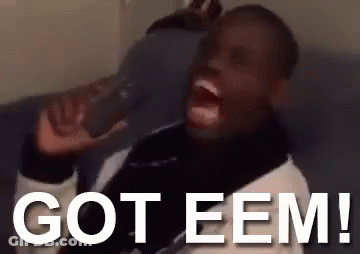 A Man Is Sitting On A Couch Drinking From A Bottle With The Words `` Got Eem '' Written On It . GIF