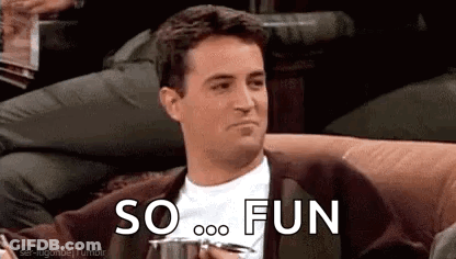 A Man Is Sitting On A Couch Holding A Cup And Saying `` So Fun '' While Holding A Cup Of Coffee . GIF