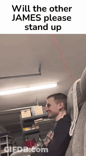A Man Is Sitting On A Couch In A Garage With A Caption That Says Will The Other James Please Stand Up GIF