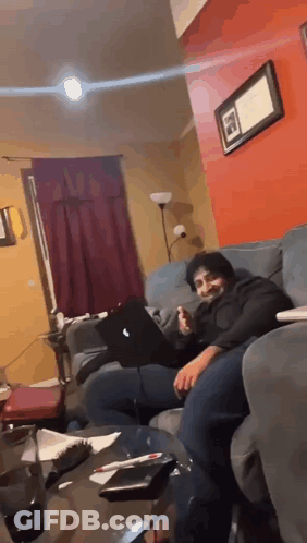 Man Sitting On Couch With Laptop GIF