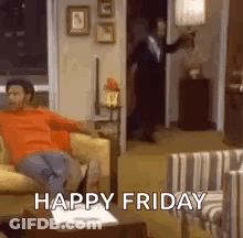 A Man Is Sitting On A Couch In A Living Room With The Words `` Happy Friday '' Written On It . GIF