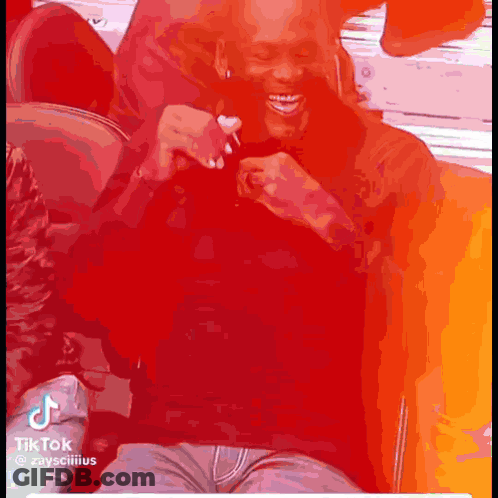 Man Laughing Sitting On Couch With Phone GIF