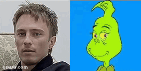 A Man Is Sitting On A Couch Next To A Picture Of A Grinch . GIF