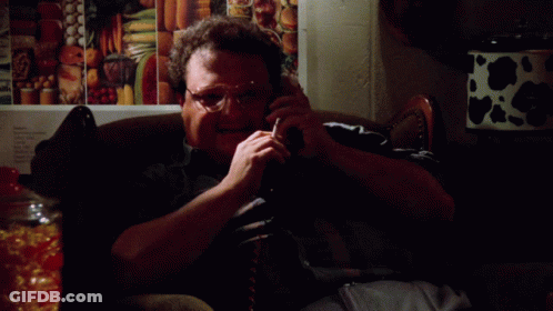 A Man Is Sitting On A Couch Talking On A Cell Phone And The Words Excellent Are On The Bottom GIF