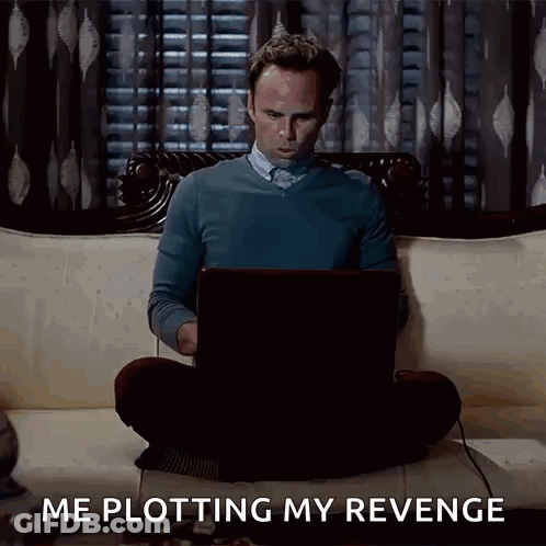 A Man Is Sitting On A Couch Using A Laptop Computer And Says Me Plotting My Revenge . GIF