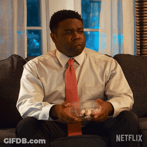 A Man Is Sitting On A Couch With A Netflix Logo On The Bottom GIF