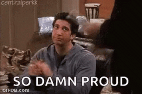 A Man Is Sitting On A Couch With His Hands Folded And The Words `` So Damn Proud '' . GIF
