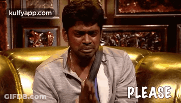A Man Is Sitting On A Couch With His Hands Folded In Prayer And The Word Please Written On The Bottom . GIF