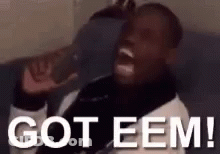 A Man Is Sitting On A Couch With His Mouth Open And Says `` Got Eem '' . GIF