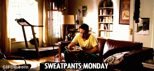 A Man Is Sitting On A Couch With Sweatpants Monday Written On It GIF