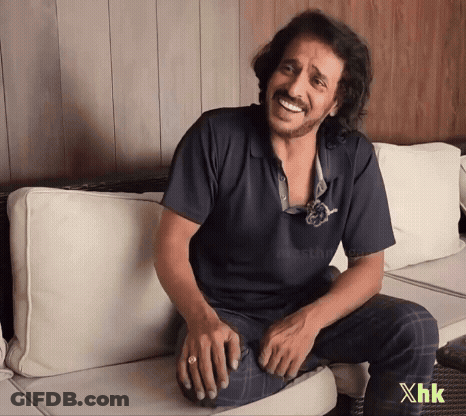 A Man Is Sitting On A Couch With The Letters Xhk On The Bottom GIF