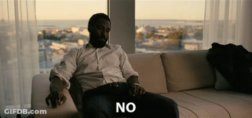 A Man Is Sitting On A Couch With The Word No Written On The Bottom GIF