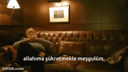 A Man Is Sitting On A Couch With The Words Allahima Şükretmekle Mesgulum Above Him GIF