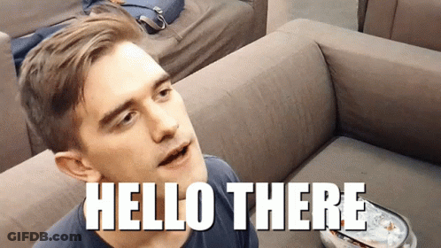 A Man Is Sitting On A Couch With The Words Hello There Above Him GIF