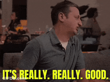 A Man Is Sitting On A Couch With The Words It 'S Really Really Good Behind Him GIF