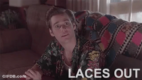 A Man Is Sitting On A Couch With The Words `` Laces Out '' Written On The Screen . GIF